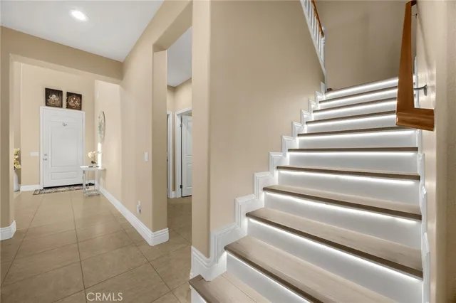 a view of an entryway with wooden floor and a chandelier
