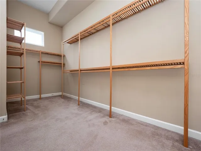 a spacious bathroom with a vanity a sink a mirror and a bathtub