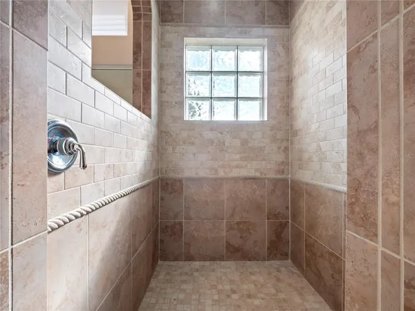 a white bath tub sitting in a bathroom next to a window
