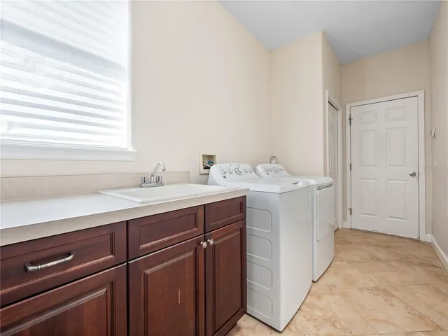 a kitchen with kitchen island granite countertop a sink counter top space appliances and cabinets