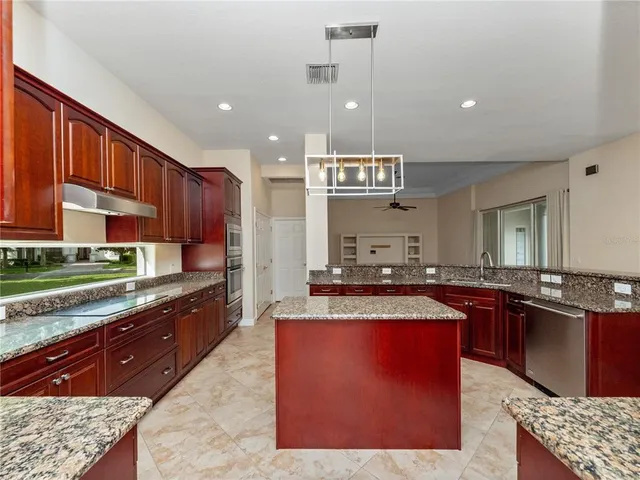 a view of a kitchen with a sink and dishwasher cabinet with wooden floor