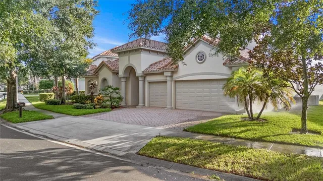 a front view of a house with a yard and garage