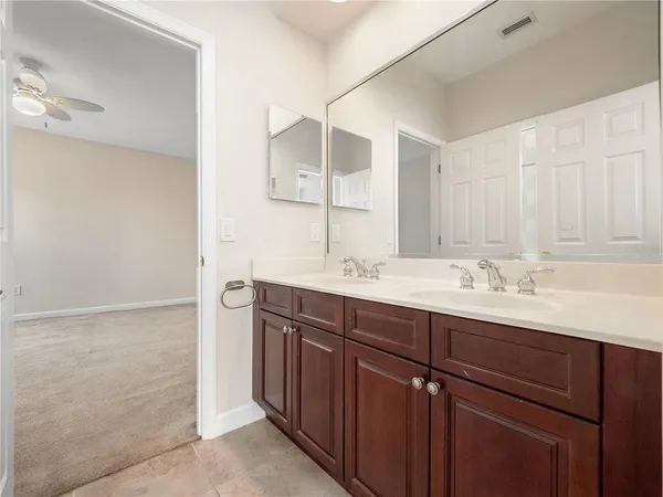a white toilet and tub sitting next to a bathroom sink
