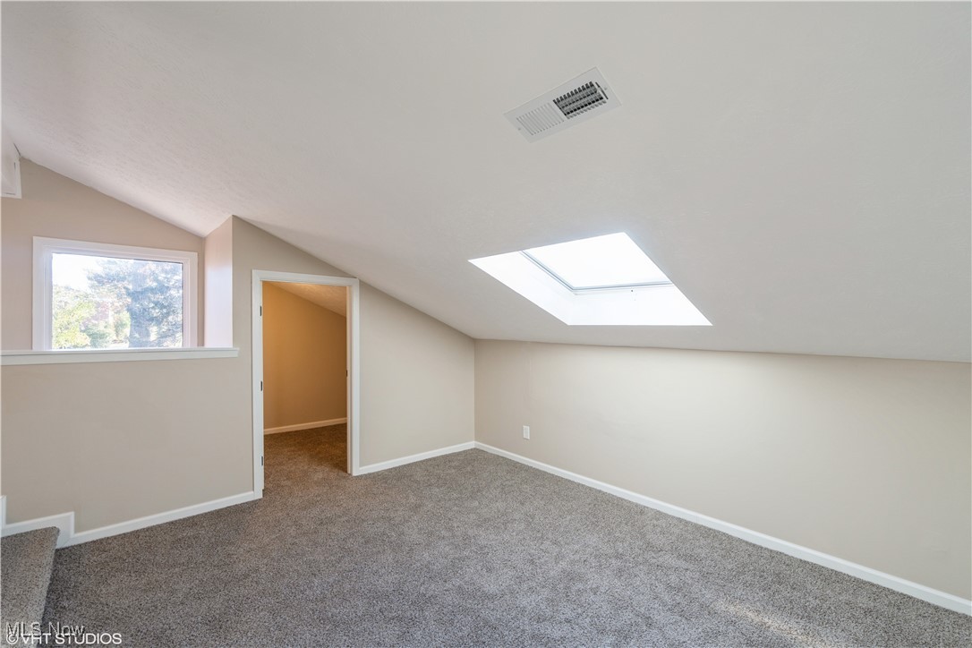 3725 Mayfield Road Cleveland Heights, OH 44121 - Photo 11 of 16 Bonus room featuring vaulted ceiling with skylight and carpet flooring