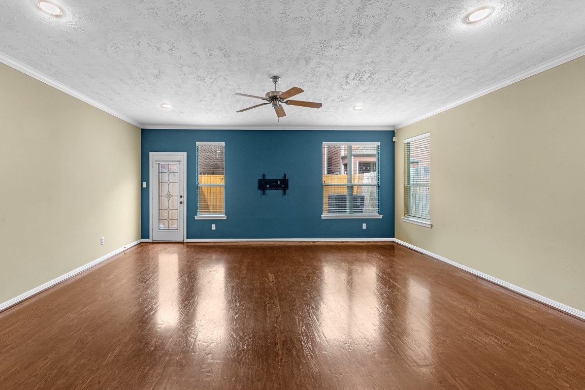5228 Larkin Street Houston, TX 77007 - Photo 11 of 29 a view of an empty room with window and wooden floor