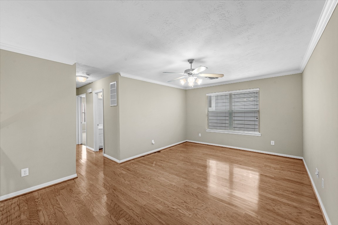 5228 Larkin Street Houston, TX 77007 - Photo 14 of 29 a view of an empty room with wooden floor and a window