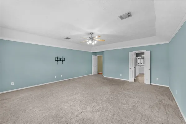 a view of an empty room with a ceiling fan