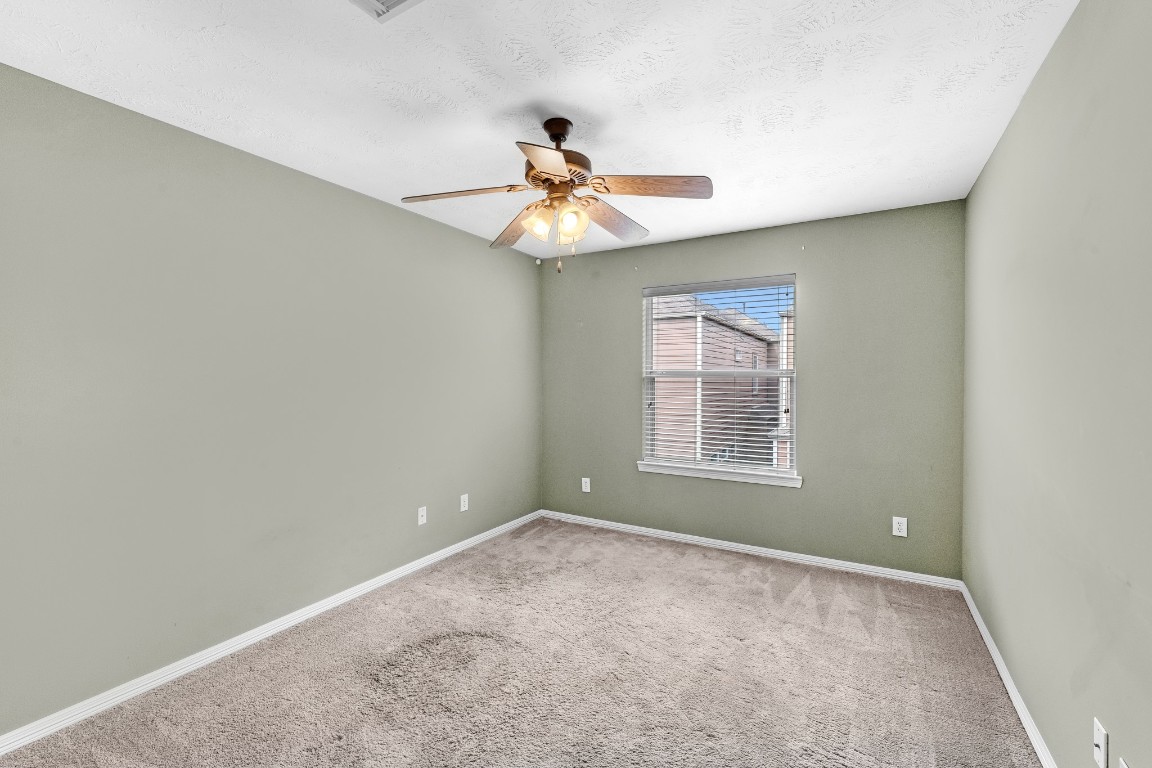 5228 Larkin Street Houston, TX 77007 - Photo 22 of 29 a view of an empty room with a window and a fan
