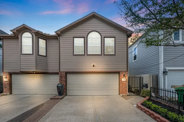 a front view of a house with garage