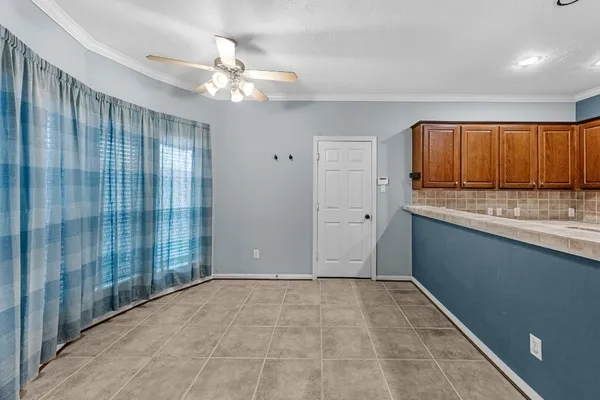 a view of kitchen with kitchen island granite countertop cabinets and window