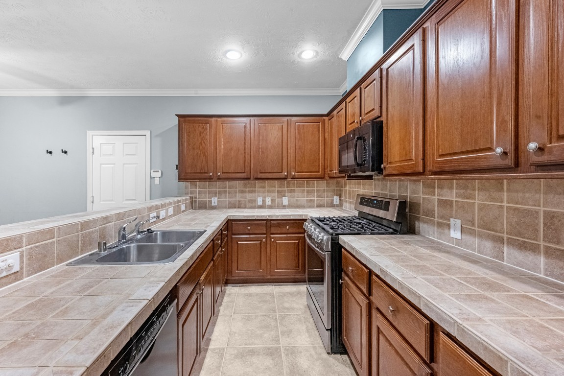 5228 Larkin Street Houston, TX 77007 - Photo 8 of 29 a kitchen with granite countertop stainless steel appliances a sink stove and cabinets