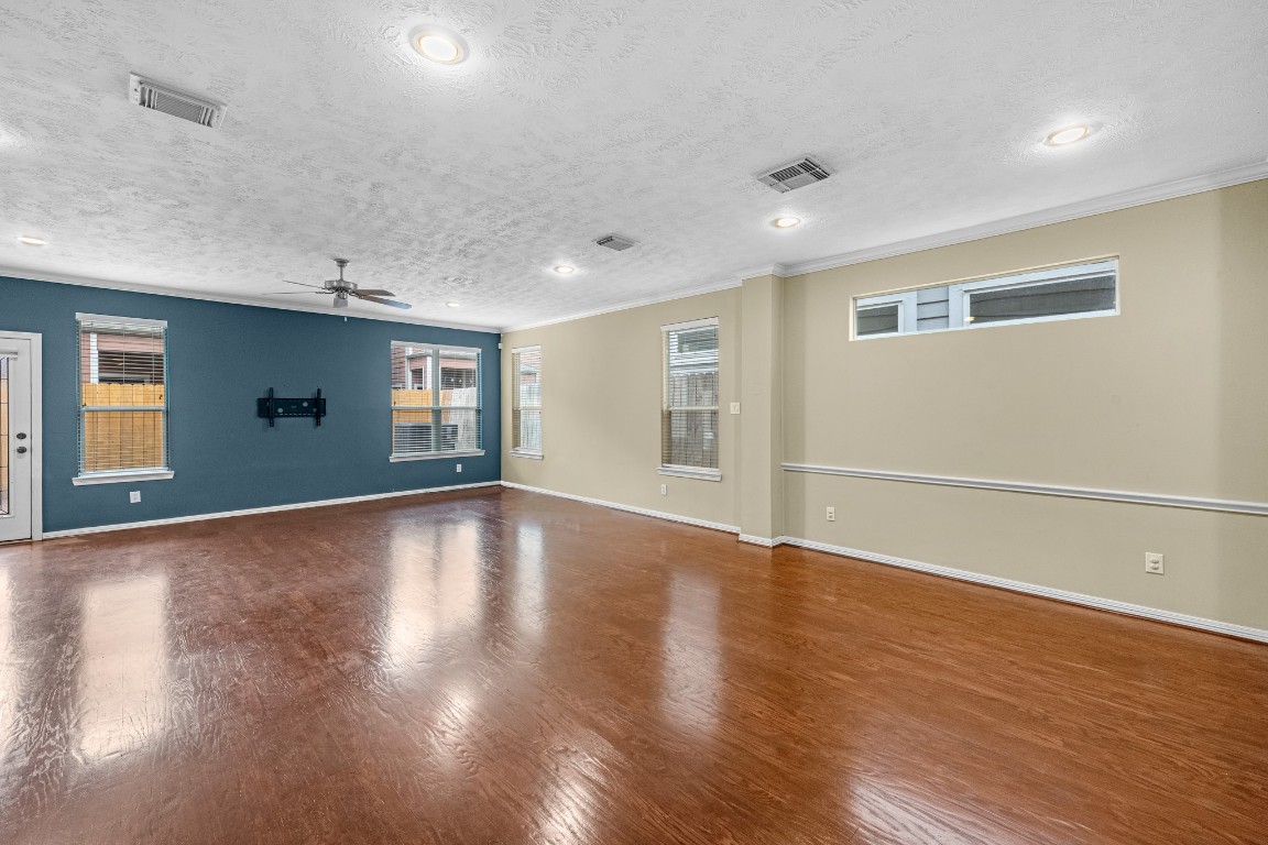 5228 Larkin Street Houston, TX 77007 - Photo 9 of 29 a view of empty room with wooden floor and fan