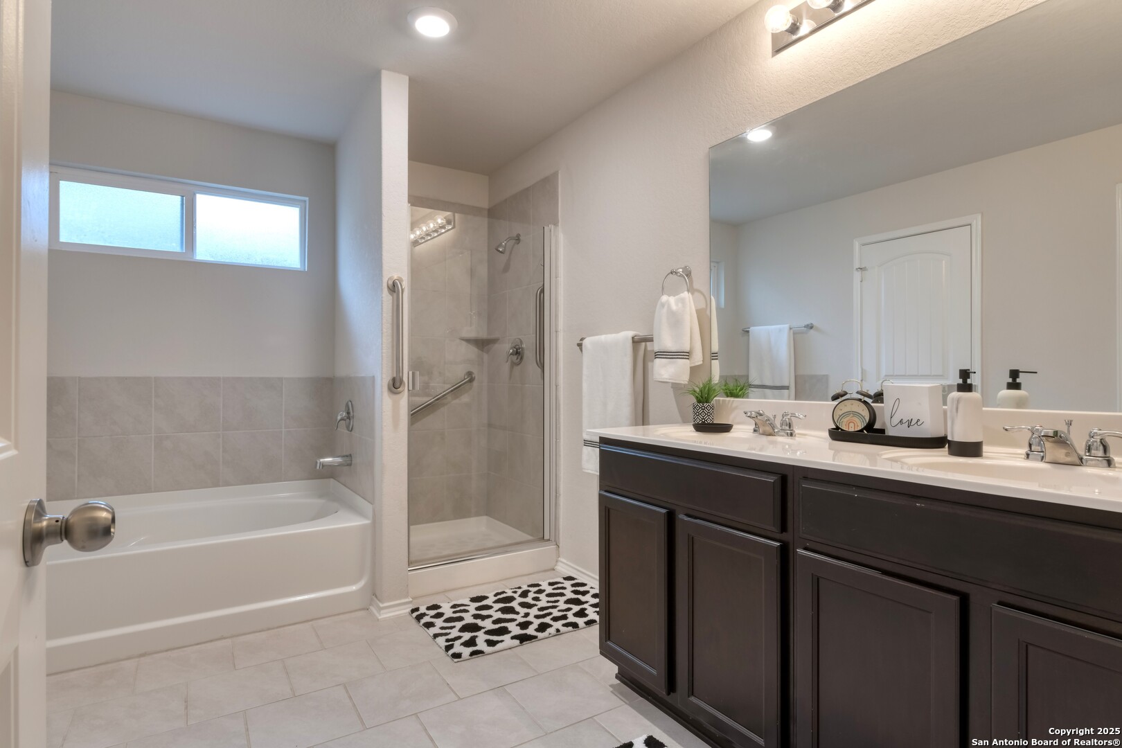 29624 Copper Crossing Bulverde, TX 78163 - Photo 17 of 33 a bathroom with a bathtub a shower a sink and a mirror