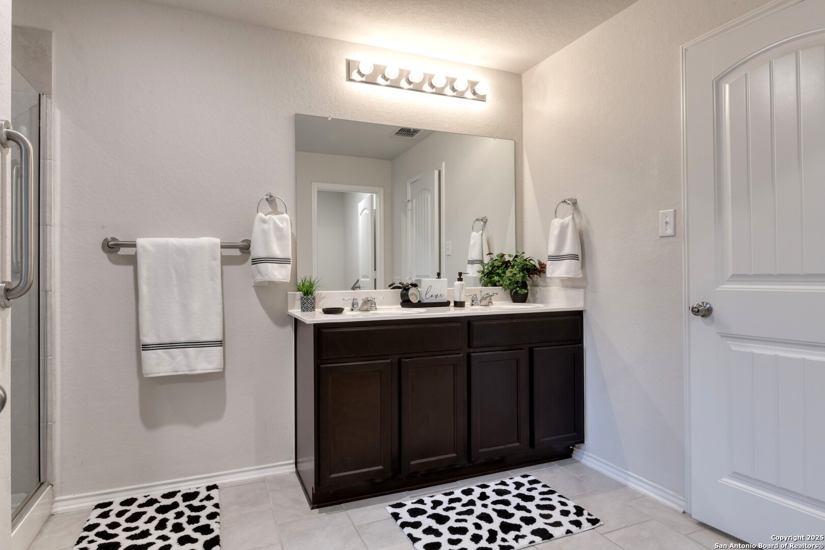 29624 Copper Crossing Bulverde, TX 78163 - Photo 18 of 33 a bathroom with a sink a mirror and a shower