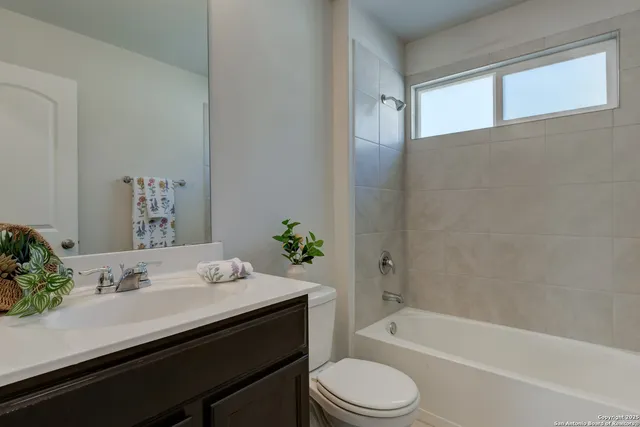 a bathroom with a sink a toilet and bathtub