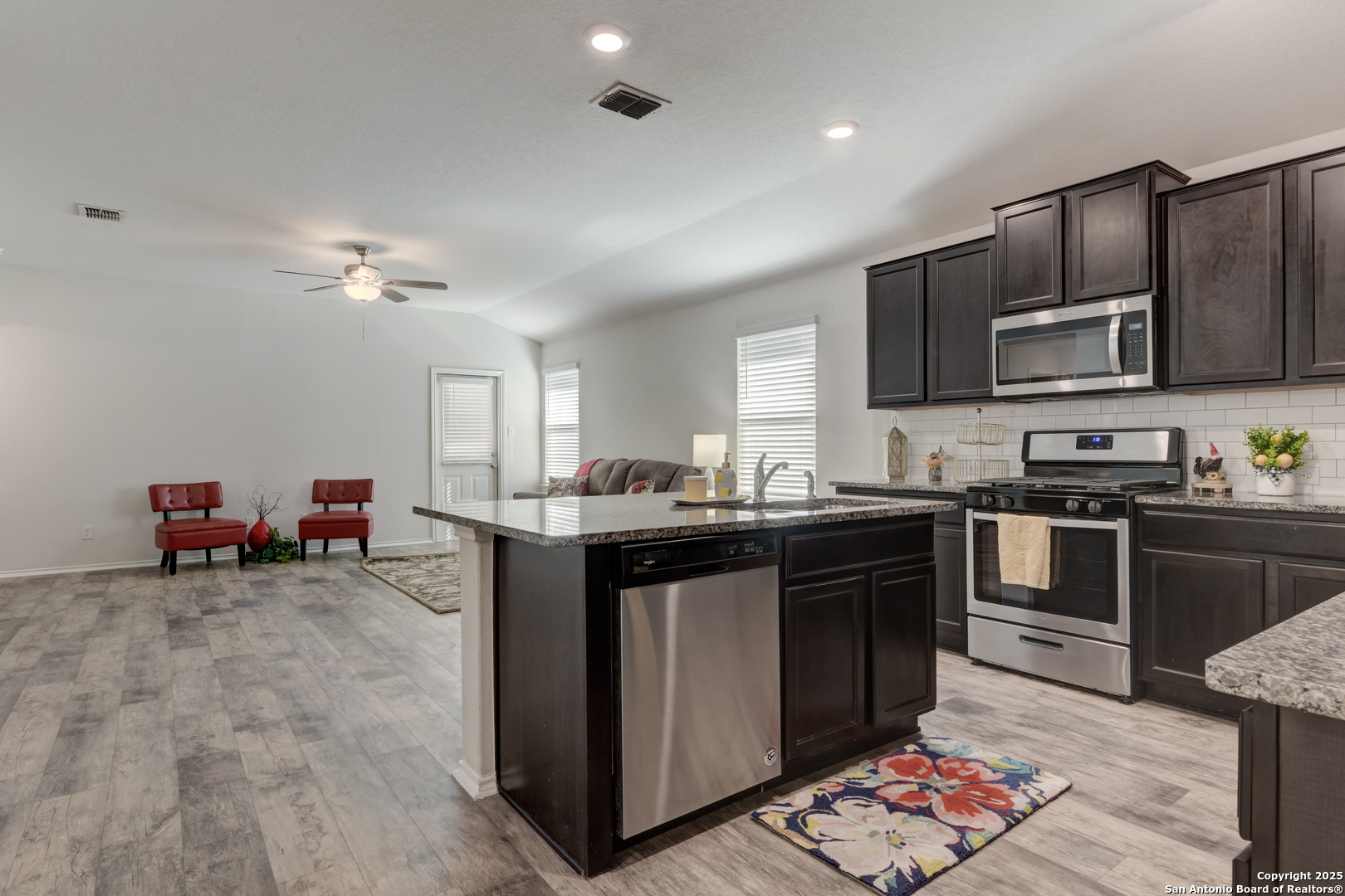 29624 Copper Crossing Bulverde, TX 78163 - Photo 6 of 33 a kitchen with stainless steel appliances granite countertop a sink dishwasher stove and refrigerator