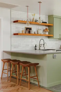 a room with stainless steel appliances kitchen island granite countertop furniture and wooden floor
