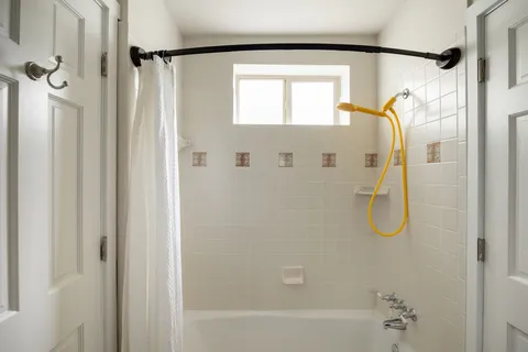 a bathroom with a shower and a tub
