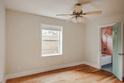 a view of a room with a window and a ceiling fan