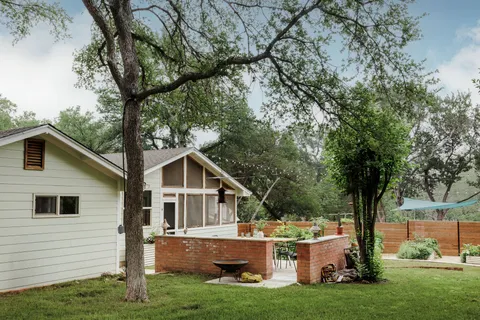 a front view of house with yard and green space
