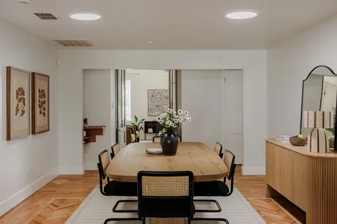 a view of a dining room with furniture and wooden floor