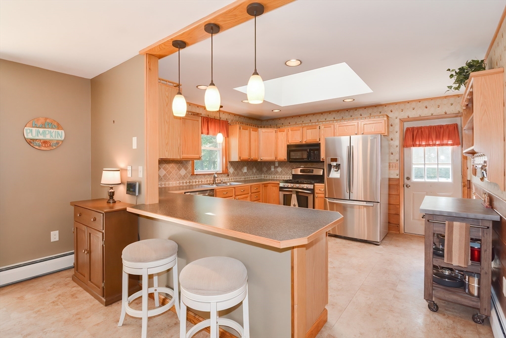100 Cutler Road Warren, MA 01083 - Photo 12 of 42 a kitchen with stainless steel appliances granite countertop a sink a stove and a refrigerator