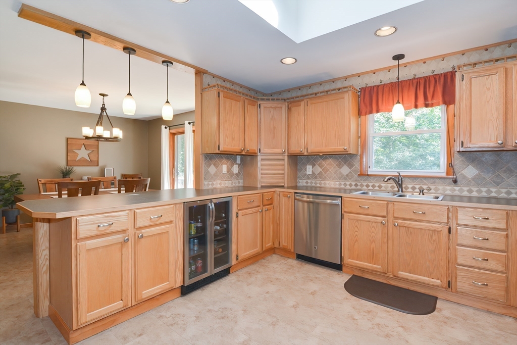 100 Cutler Road Warren, MA 01083 - Photo 13 of 42 a kitchen with kitchen island granite countertop a sink cabinets and window