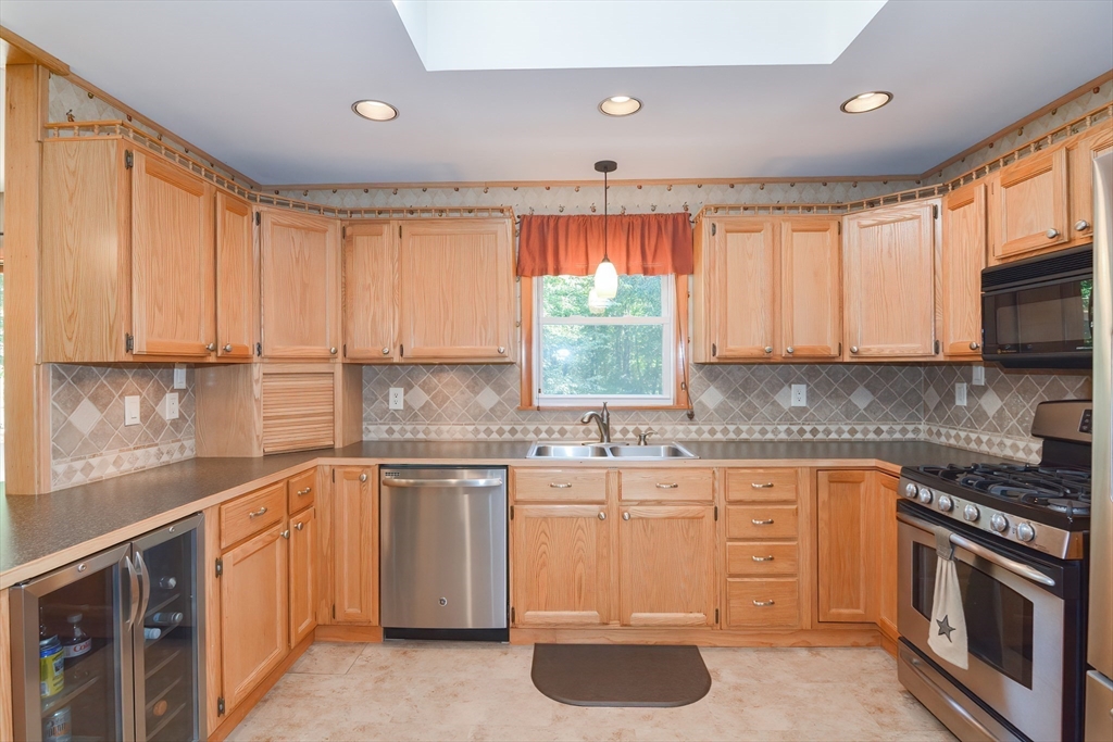 100 Cutler Road Warren, MA 01083 - Photo 14 of 42 a kitchen with stainless steel appliances granite countertop a stove a sink and a microwave