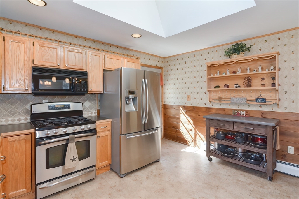 100 Cutler Road Warren, MA 01083 - Photo 15 of 42 a kitchen with stainless steel appliances a stove a microwave and a refrigerator