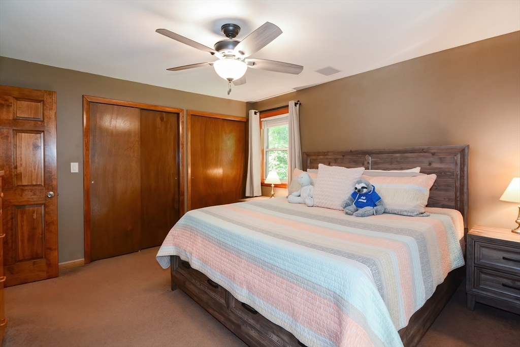 100 Cutler Road Warren, MA 01083 - Photo 16 of 42 a bedroom with a large bed and a chandelier
