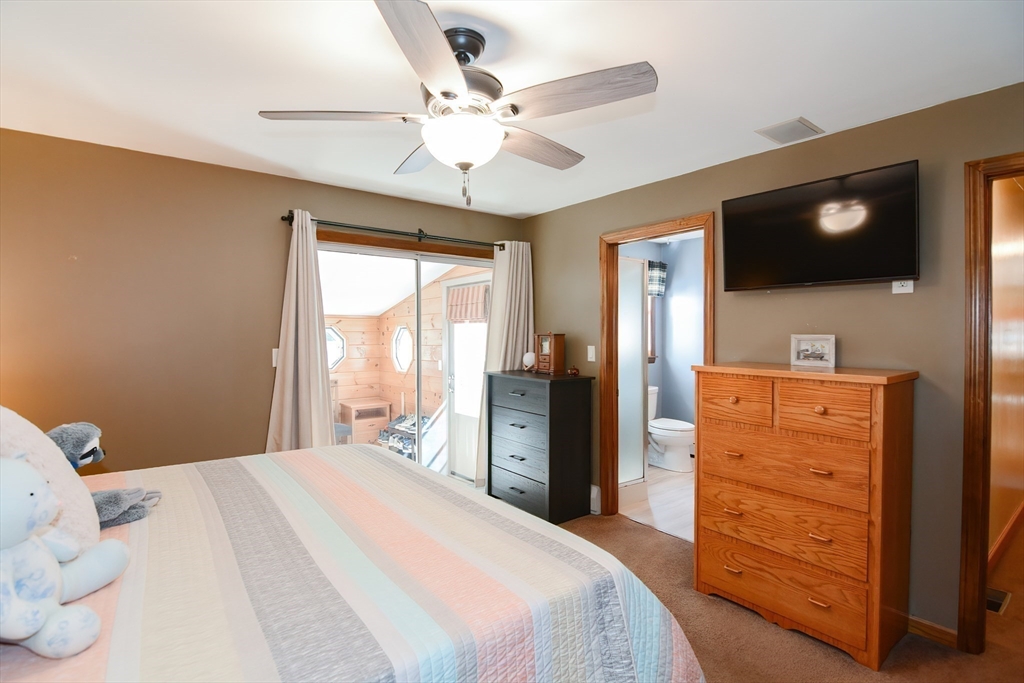 100 Cutler Road Warren, MA 01083 - Photo 17 of 42 a bedroom with a large bed and a flat tv screen on dresser