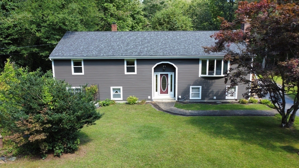 100 Cutler Road Warren, MA 01083 - Photo 2 of 42 a front view of a house with a garden