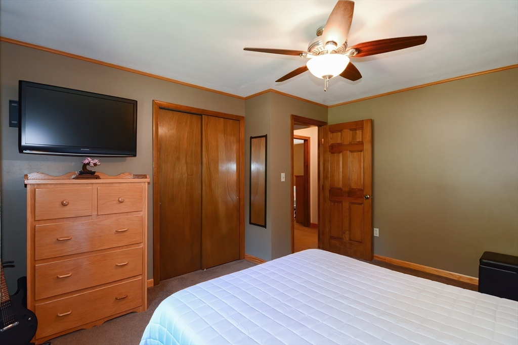 100 Cutler Road Warren, MA 01083 - Photo 23 of 42 a bedroom with a bed and a flat screen tv