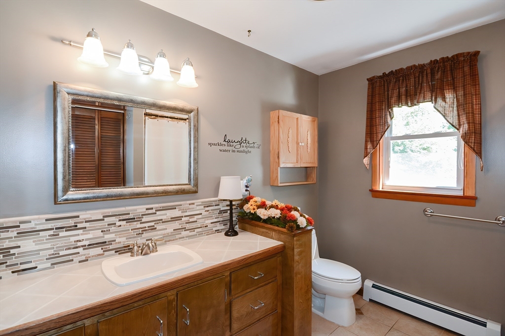 100 Cutler Road Warren, MA 01083 - Photo 24 of 42 a bathroom with a sink toilet and window