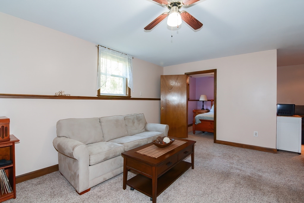 100 Cutler Road Warren, MA 01083 - Photo 27 of 42 a living room with furniture and a chandelier