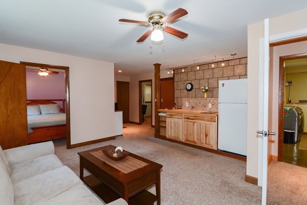100 Cutler Road Warren, MA 01083 - Photo 28 of 42 a living room with furniture a ceiling fan and a rug