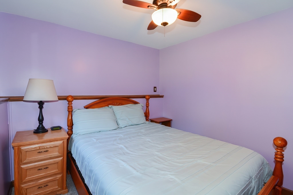 100 Cutler Road Warren, MA 01083 - Photo 30 of 42 a bedroom with a bed and a chandelier