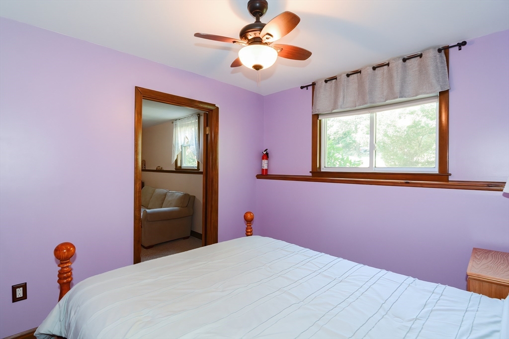 100 Cutler Road Warren, MA 01083 - Photo 31 of 42 a bedroom with a bed and a chandelier