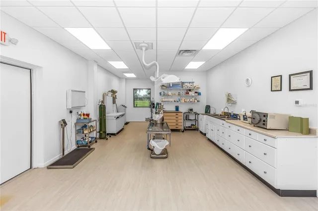 a view of a dining room with furniture a chandelier and wooden floor
