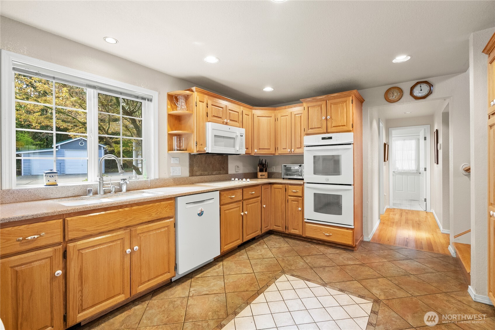 8320 East Grapeview Loop Road Allyn, WA 98524 - Photo 8 of 38 a kitchen with a sink window and cabinets