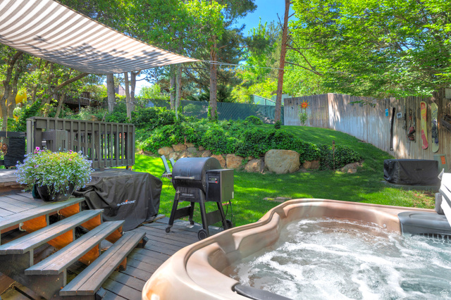3310 Creek Road Salt Lake City, UT 84121 - Photo 40 of 49 Expansive backyard featuring a built-in hot tub, multi-level wood deck, and a shaded pergola