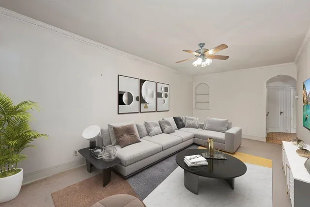 a living room with furniture and a potted plant