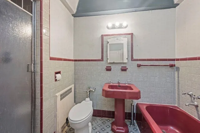 a bathroom with a sink a toilet and a mirror