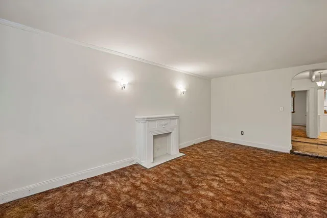 a view of an empty room and a fireplace