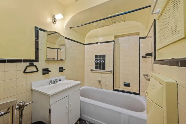 a bathroom with a sink a mirror toilet and bathtub