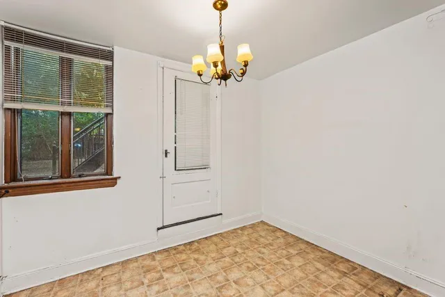 a view of a chandelier fan and wooden floor in a room