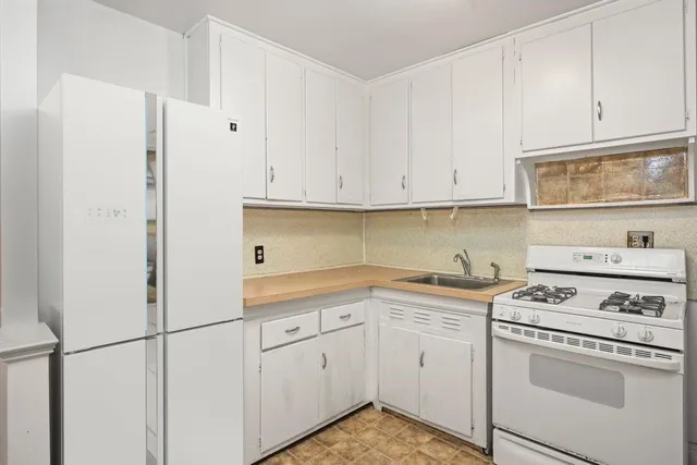 a kitchen with cabinets appliances and a sink