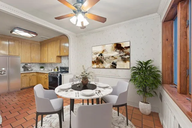 a dining room with furniture potted plants and wooden floor
