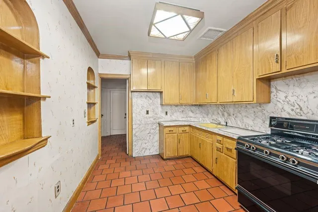 a kitchen with a stove a sink and a refrigerator
