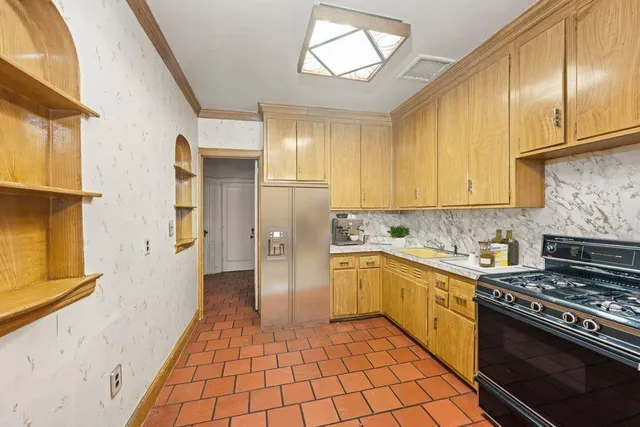 a kitchen with a stove a sink and a refrigerator